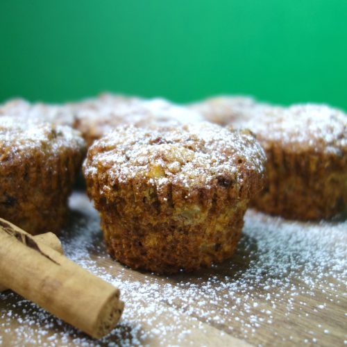 apple cinnamon muffins served on a wooden board