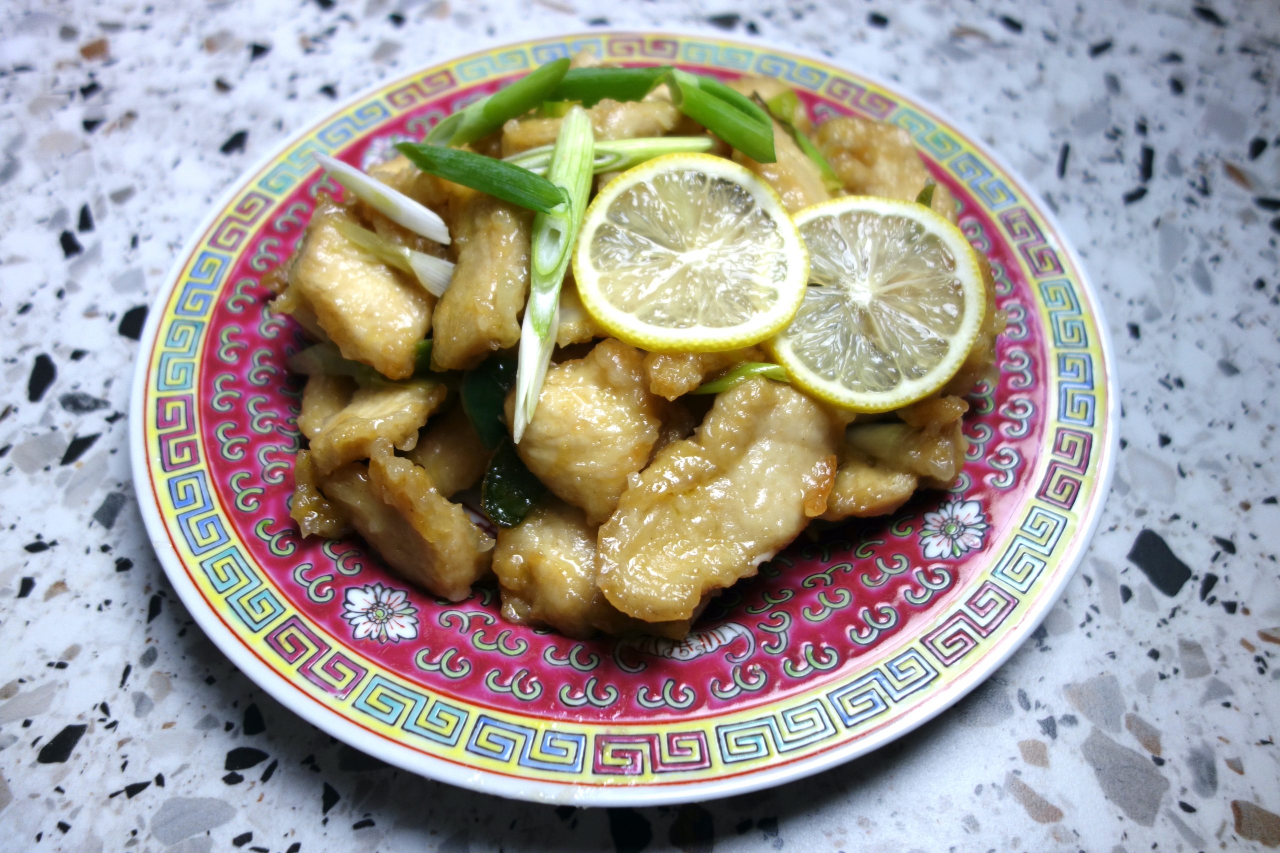 Chinese Lemon Chicken served on a red oriental style plate