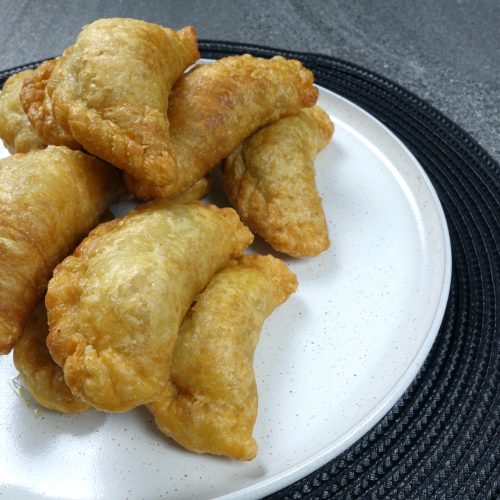 malaysian beef curry puffs served on a white plate