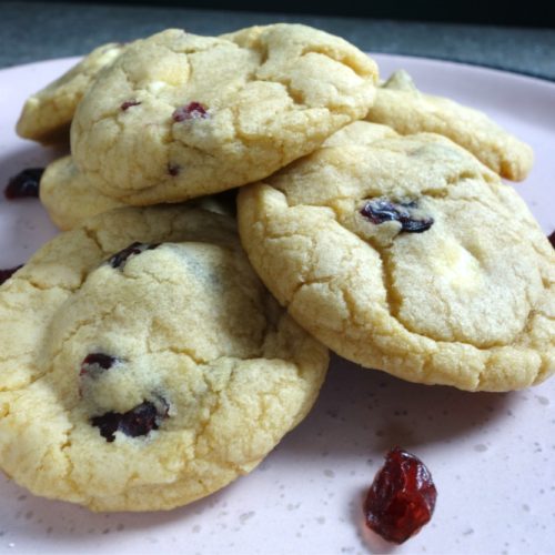 white chocolate and cranberry cookies served on a pink plate