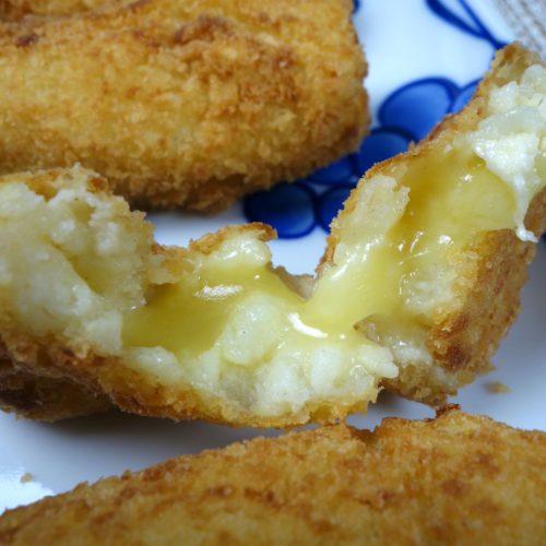 Camembert Croquette with melted cheese oozing from the inside.